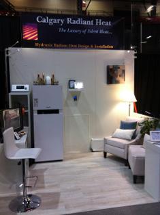 Calgary Radiant Heat home show booth display with white colour scheme of Viessmann boiler system and cross connection control device on display..